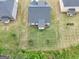 Aerial view of a home with a well-maintained lawn and a wooded property line at 1225 Hibiscus Way, Mcdonough, GA 30253