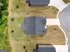 Aerial view of a home with a dark roof, surrounded by green grass and neighborhood roads at 1225 Hibiscus Way, Mcdonough, GA 30253
