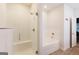 Modern bathroom featuring a glass-enclosed shower with seat and a separate soaking tub with tile surround at 1225 Hibiscus Way, Mcdonough, GA 30253