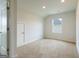 Empty carpeted room featuring a closet and a single window providing natural light at 1225 Hibiscus Way, Mcdonough, GA 30253