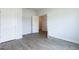 Bright bedroom with luxury vinyl plank flooring, white walls, and two doors leading to additional rooms at 1225 Hibiscus Way, Mcdonough, GA 30253