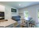 Open-concept dining area with seating, view of the backyard, and modern decor at 1225 Hibiscus Way, Mcdonough, GA 30253