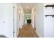 Hallway featuring luxury vinyl plank flooring, white doors, and view of living area at 1225 Hibiscus Way, Mcdonough, GA 30253