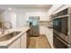 Modern kitchen with stainless steel appliances, granite countertops, and white cabinetry at 1225 Hibiscus Way, Mcdonough, GA 30253