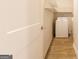 Laundry room featuring a washer, shelving, and wood-look vinyl floors at 1225 Hibiscus Way, Mcdonough, GA 30253