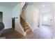 Bright entryway featuring a carpeted staircase with white trim and wood railing, leading to the upper level at 1225 Hibiscus Way, Mcdonough, GA 30253