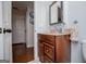 Bathroom featuring wooden vanity with granite countertop and framed mirror at 97 Coral Dr, Whitesburg, GA 30185