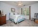 Cozy bedroom with blue metal frame bed, and a large window with green tree views at 97 Coral Dr, Whitesburg, GA 30185