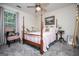 Charming bedroom features a four-poster bed, light walls, and natural light from a window at 97 Coral Dr, Whitesburg, GA 30185