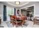 Formal dining room features a large wood table, wainscoting and view to a carpeted staircase at 97 Coral Dr, Whitesburg, GA 30185