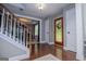 Inviting foyer featuring hardwood floors, an ornate front door, and a staircase leading to the upper level at 97 Coral Dr, Whitesburg, GA 30185