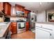 Well-equipped kitchen boasting stainless steel appliances, wood cabinets, and a convenient pantry at 97 Coral Dr, Whitesburg, GA 30185