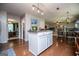 Bright kitchen boasts an island with a countertop, hardwood floors, and an eat-in breakfast area at 97 Coral Dr, Whitesburg, GA 30185