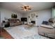 Comfortable living room showcasing plush seating, a fireplace, and a ceiling fan for added comfort at 97 Coral Dr, Whitesburg, GA 30185