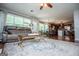 Open-concept living room featuring a cozy seating area, large windows, and seamless access to the kitchen at 97 Coral Dr, Whitesburg, GA 30185