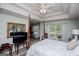 Bright main bedroom features a tray ceiling, a four-poster bed, ceiling fan, and ample natural light at 97 Coral Dr, Whitesburg, GA 30185