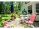 A patio with an umbrella, table and chairs, flowers and a rocking chair at 97 Coral Dr, Whitesburg, GA 30185