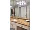 Bathroom featuring a granite countertop, white cabinets, a large mirror, and good lighting at 2119 Pine Heights Ne Dr, Atlanta, GA 30324