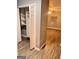 Bedroom featuring a closet with custom shelving, ceiling fan, and wood-look flooring at 2119 Pine Heights Ne Dr, Atlanta, GA 30324