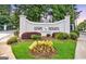 Landscaped entrance to Lenox Heights Condominiums with decorative lighting, mature trees, and manicured flower beds at 2119 Pine Heights Ne Dr, Atlanta, GA 30324