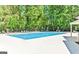 Community pool with lounge chairs surrounded by mature trees at 2119 Pine Heights Ne Dr, Atlanta, GA 30324