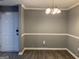 Inviting dining room featuring classic chair rail molding and modern chandelier at 2119 Pine Heights Ne Dr, Atlanta, GA 30324