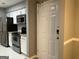 Modern kitchen with stainless steel appliances and white cabinets adjacent to entryway at 2119 Pine Heights Ne Dr, Atlanta, GA 30324