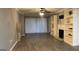 Living room featuring light-colored hard surface floors, a ceiling fan, and a fireplace with built-in shelving at 2119 Pine Heights Ne Dr, Atlanta, GA 30324