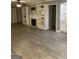 Bright living room with fireplace, built-in shelving and stylish wood-look flooring at 2119 Pine Heights Ne Dr, Atlanta, GA 30324