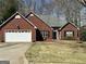 Charming single-Gathering brick home with a two-car garage and well-maintained front lawn at 12313 Riviera Dr, Fayetteville, GA 30215