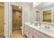 Bathroom features dual sinks, updated vanity, and a tiled walk-in shower at 105 Lake Forest Drive, Peachtree City, GA 30269