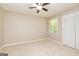 Neutral bedroom with carpet flooring, closet, natural light from window, and ceiling fan at 105 Lake Forest Drive, Peachtree City, GA 30269