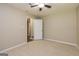 Neutral bedroom with carpet flooring, ceiling fan, and an open doorway at 105 Lake Forest Drive, Peachtree City, GA 30269