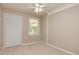 Neutral bedroom with ceiling fan, carpet flooring, closet, and natural light from window at 105 Lake Forest Drive, Peachtree City, GA 30269