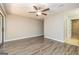 Bedroom with neutral walls, ceiling fan, new flooring, and an en suite bathroom with a tiled shower at 105 Lake Forest Drive, Peachtree City, GA 30269