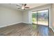 Bright bedroom with new floors, ceiling fan, and a sliding glass door to the backyard at 105 Lake Forest Drive, Peachtree City, GA 30269