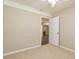 Neutral bedroom with carpet flooring, and an open doorway looking into the living room at 105 Lake Forest Drive, Peachtree City, GA 30269