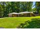 Traditional brick ranch home with mature trees, a two-car garage and a well-kept lawn at 105 Lake Forest Drive, Peachtree City, GA 30269