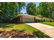 Ranch home with well-maintained landscaping, two car garage and a paved driveway at 105 Lake Forest Drive, Peachtree City, GA 30269