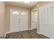 Inviting foyer featuring new flooring, a double-door entry, and a convenient coat closet at 105 Lake Forest Drive, Peachtree City, GA 30269