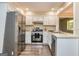 Kitchen with stainless steel appliances, white cabinets, and ample counter space at 105 Lake Forest Drive, Peachtree City, GA 30269