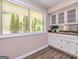 Kitchen features white cabinets, countertops, and natural light from the window at 105 Lake Forest Drive, Peachtree City, GA 30269