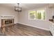 Bright living room with updated light fixture, fireplace, and large picture window at 105 Lake Forest Drive, Peachtree City, GA 30269