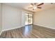 Bright living room features hardwood floors and sliding glass doors leading to the backyard at 105 Lake Forest Drive, Peachtree City, GA 30269