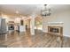 The open living space features a modern light fixture, fireplace, and updated floors at 105 Lake Forest Drive, Peachtree City, GA 30269