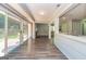Open living space features modern floors, brick fireplace, and sliding glass doors at 105 Lake Forest Drive, Peachtree City, GA 30269