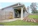Cozy back porch with a ceiling fan and a grill, perfect for outdoor dining at 234 Thyme Leaf Way, Locust Grove, GA 30248