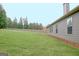 Serene backyard view with a well-maintained lawn, mature trees, and attractive home siding at 234 Thyme Leaf Way, Locust Grove, GA 30248