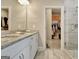 Bathroom with double sinks, granite countertop, and glass enclosed shower, as well as a walk-in closet at 234 Thyme Leaf Way, Locust Grove, GA 30248