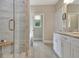 Well-lit bathroom with a glass shower, a separate tub, and a vanity with granite counters at 234 Thyme Leaf Way, Locust Grove, GA 30248